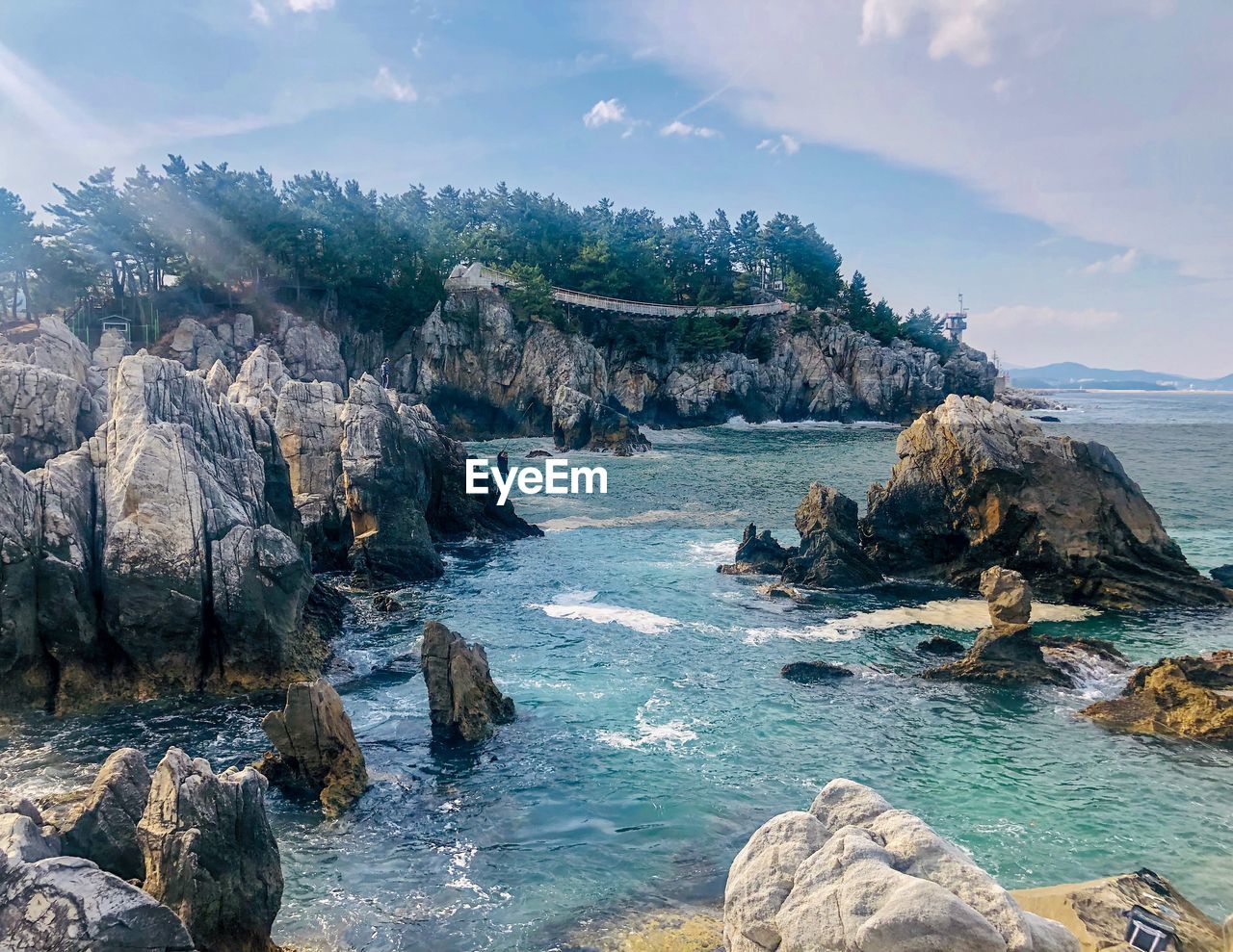 SCENIC VIEW OF ROCKS ON SHORE AGAINST SKY