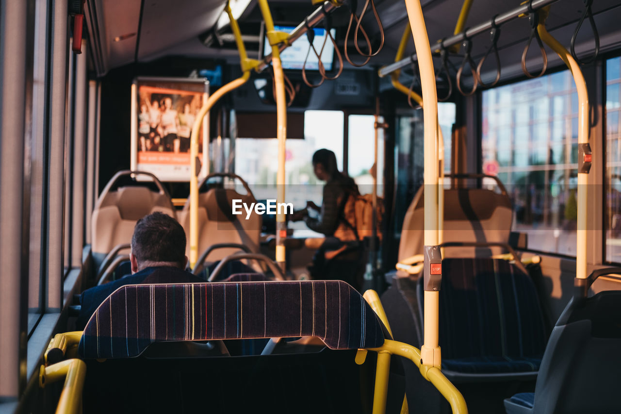 REAR VIEW OF PEOPLE IN BUS