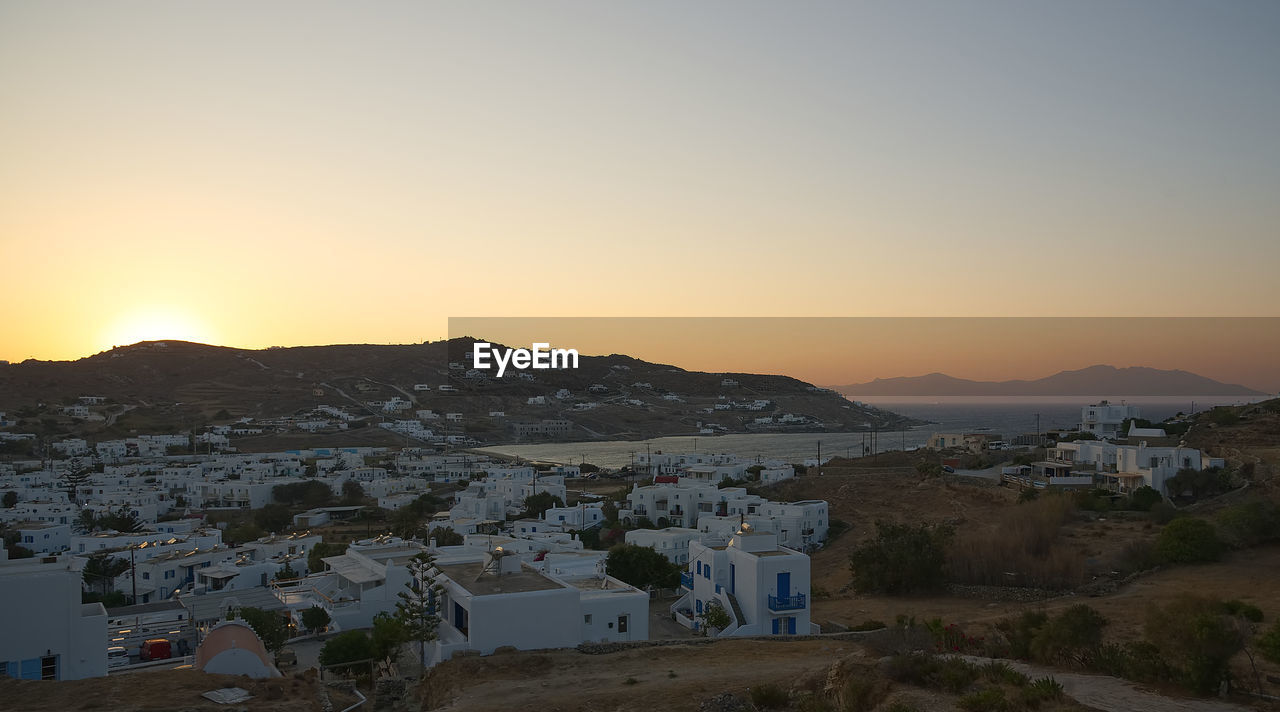 High angle shot of townscape against sky at sunset