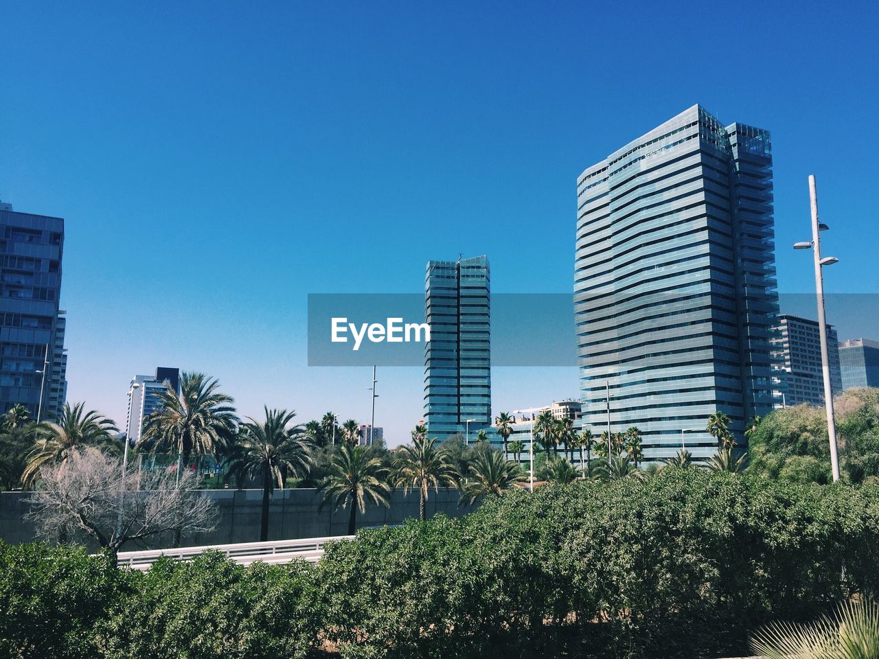 Low angle view of skyscrapers against clear blue sky