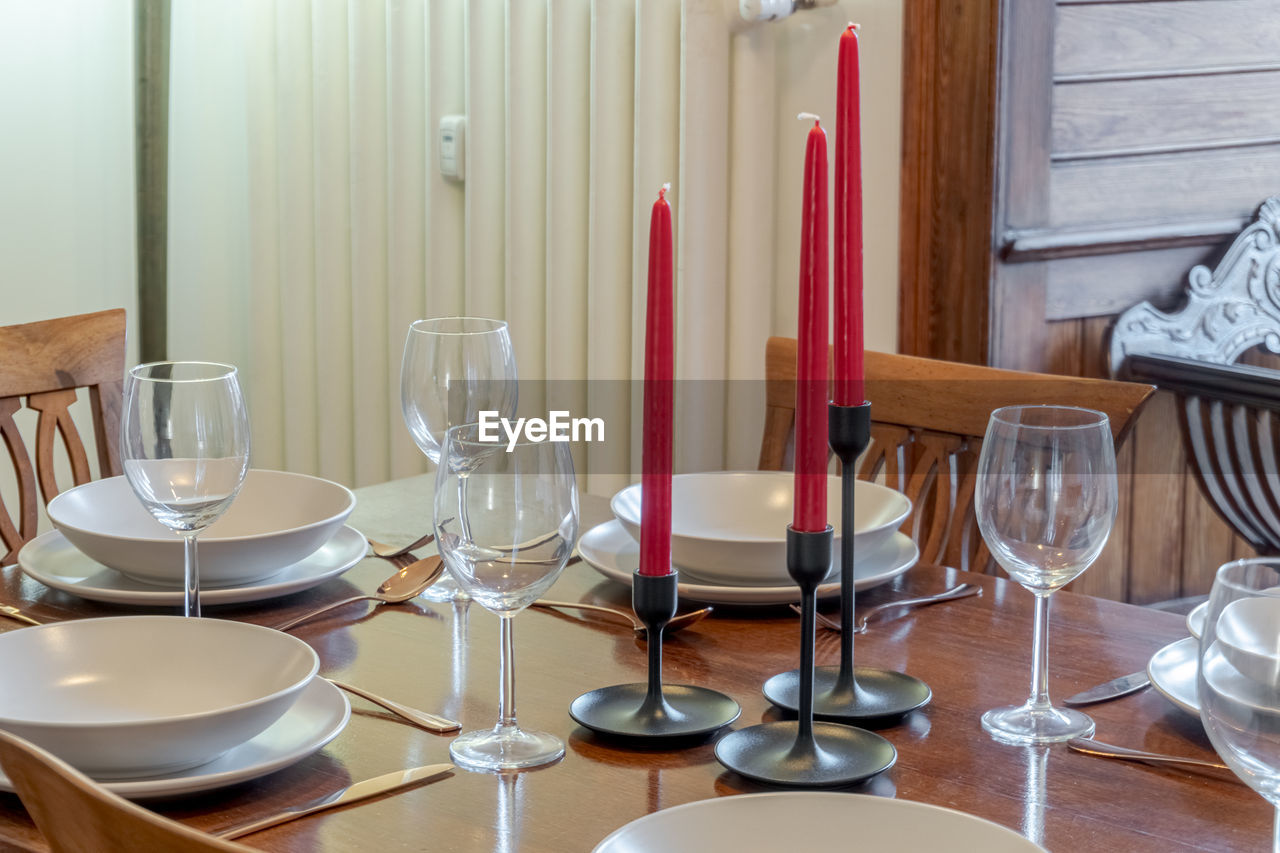 Detail of arranged table with plates and glasses