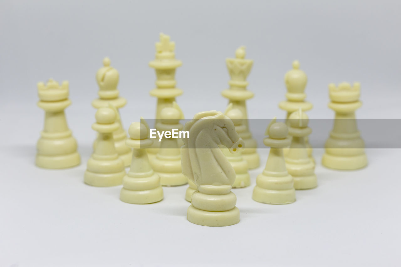 Close-up of chess pieces against white background