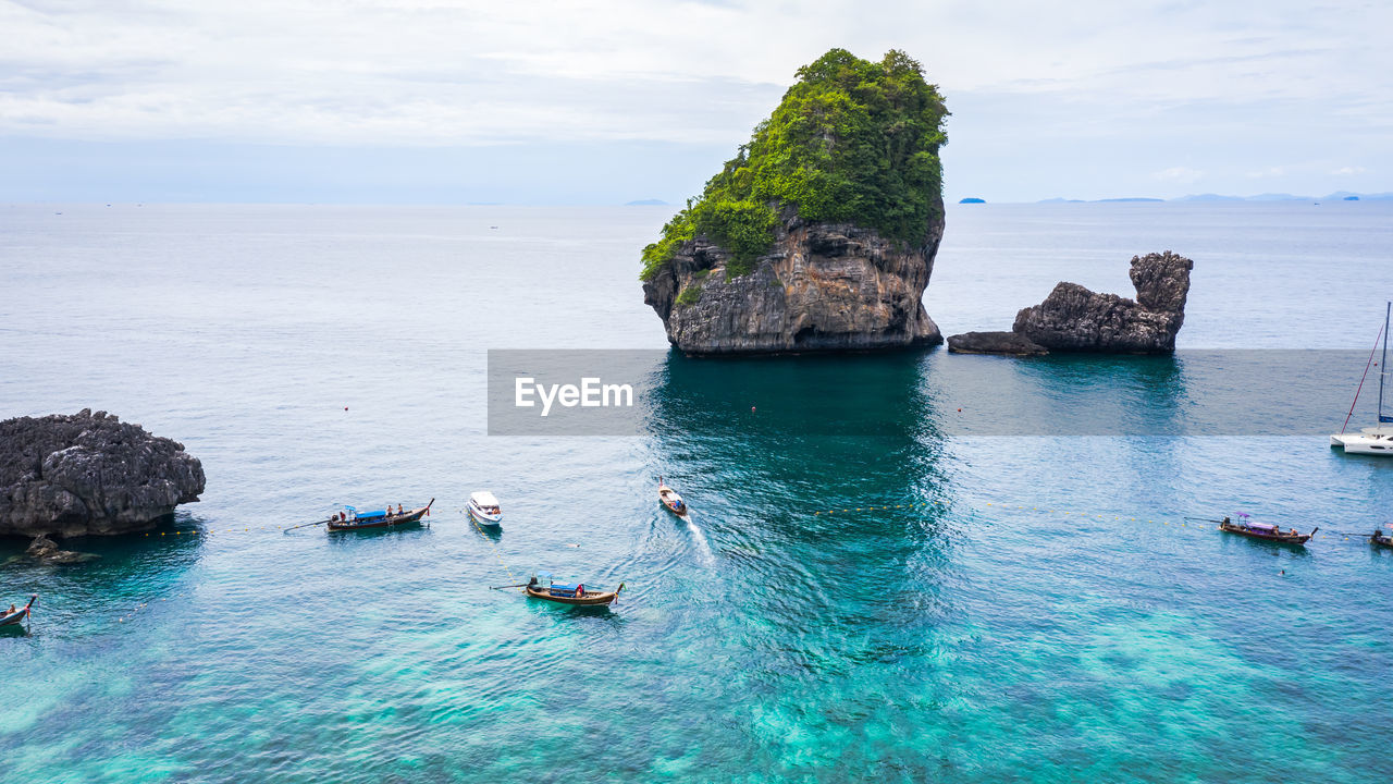 Adventure style hi season thai and foreign tourists long tail boat and driving see coral on phi phi 