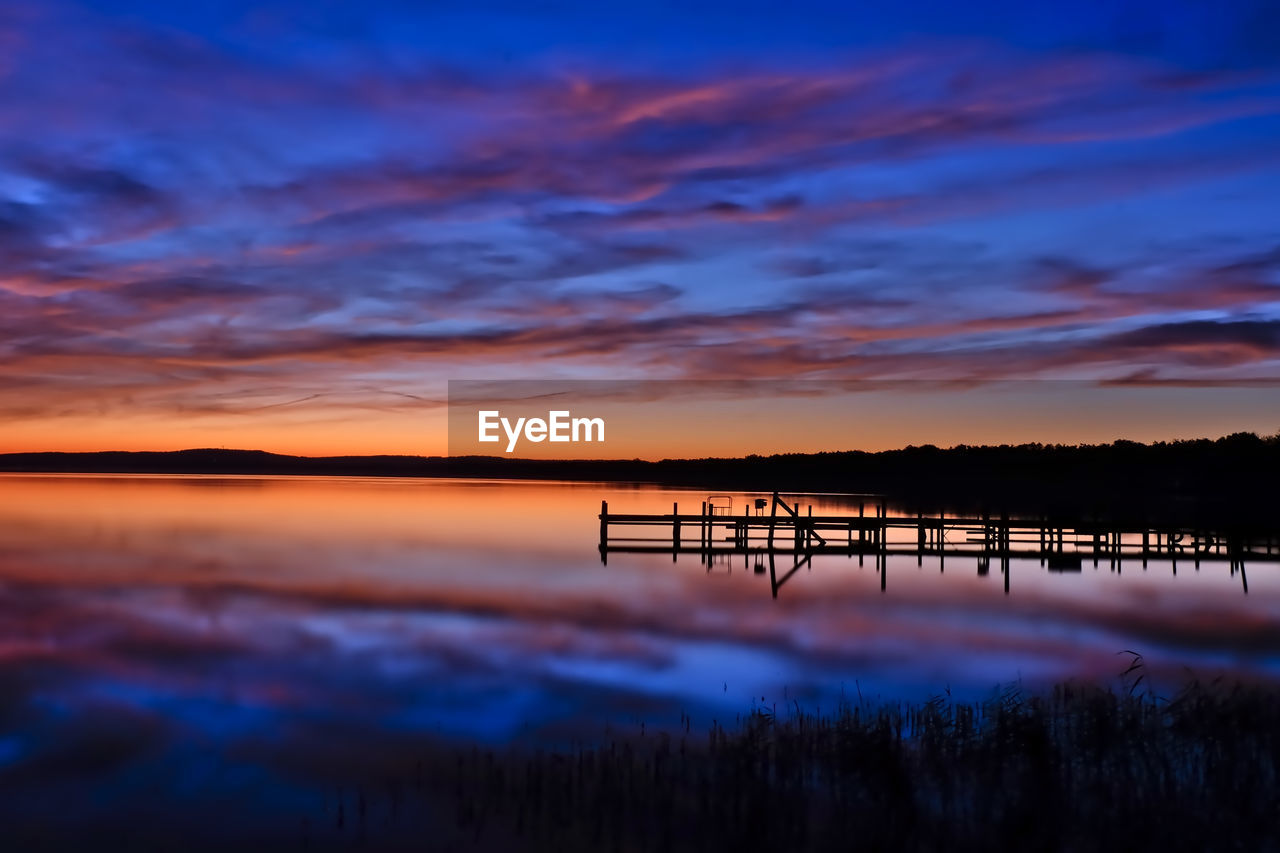 Scenic view of lake against romantic sky at sunset