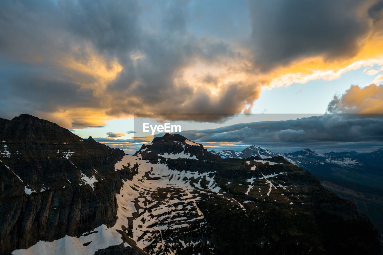 Scenic view of snowcapped mountains against sky during sunset