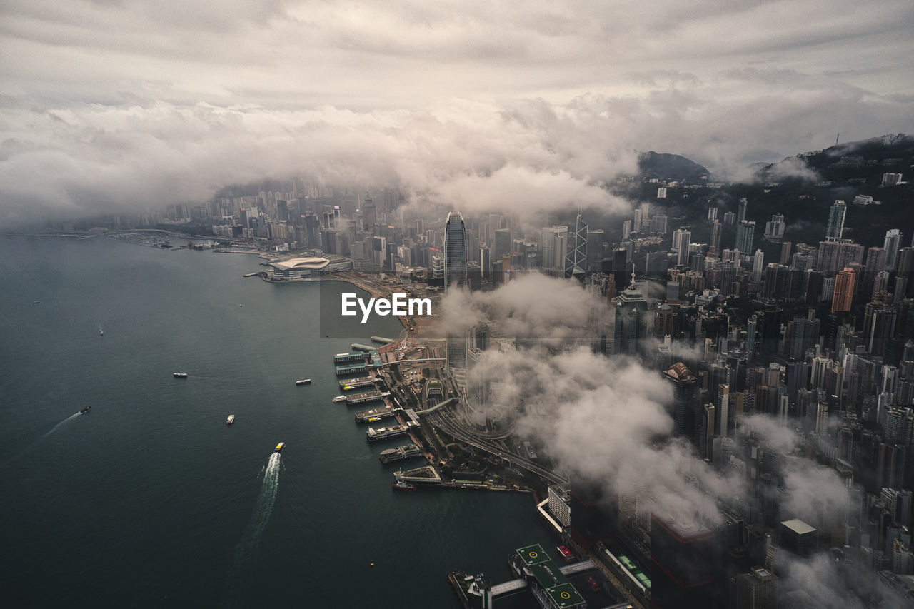 High angle view of buildings by sea against sky