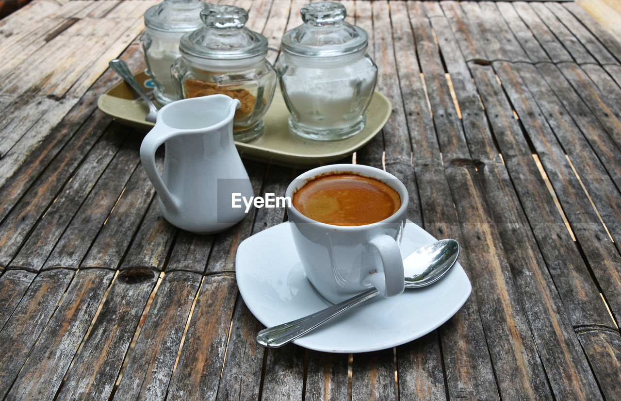 High angle view of coffee on wooden table