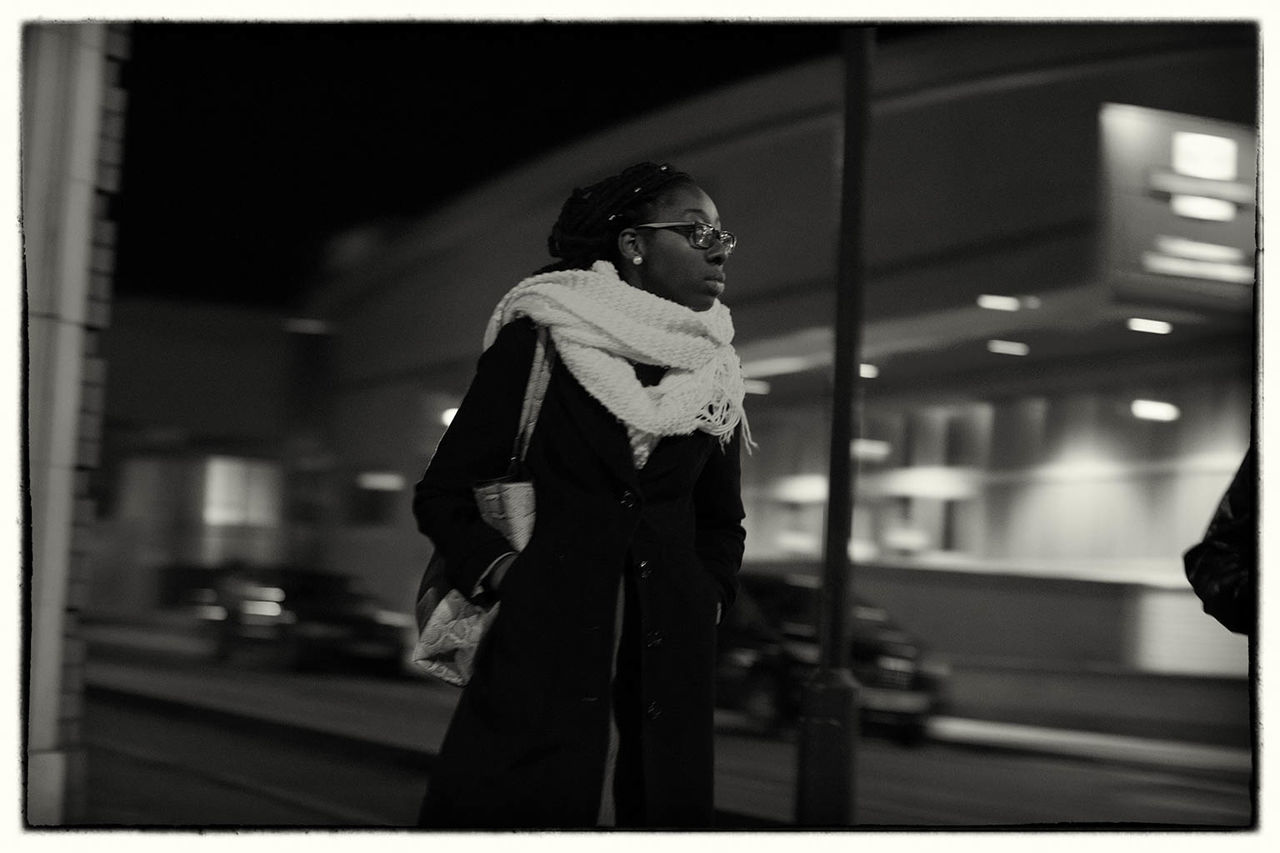 WOMAN STANDING ON CITY STREET