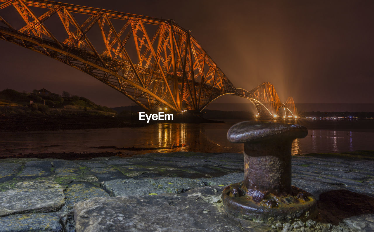 ILLUMINATED SUSPENSION BRIDGE AT NIGHT