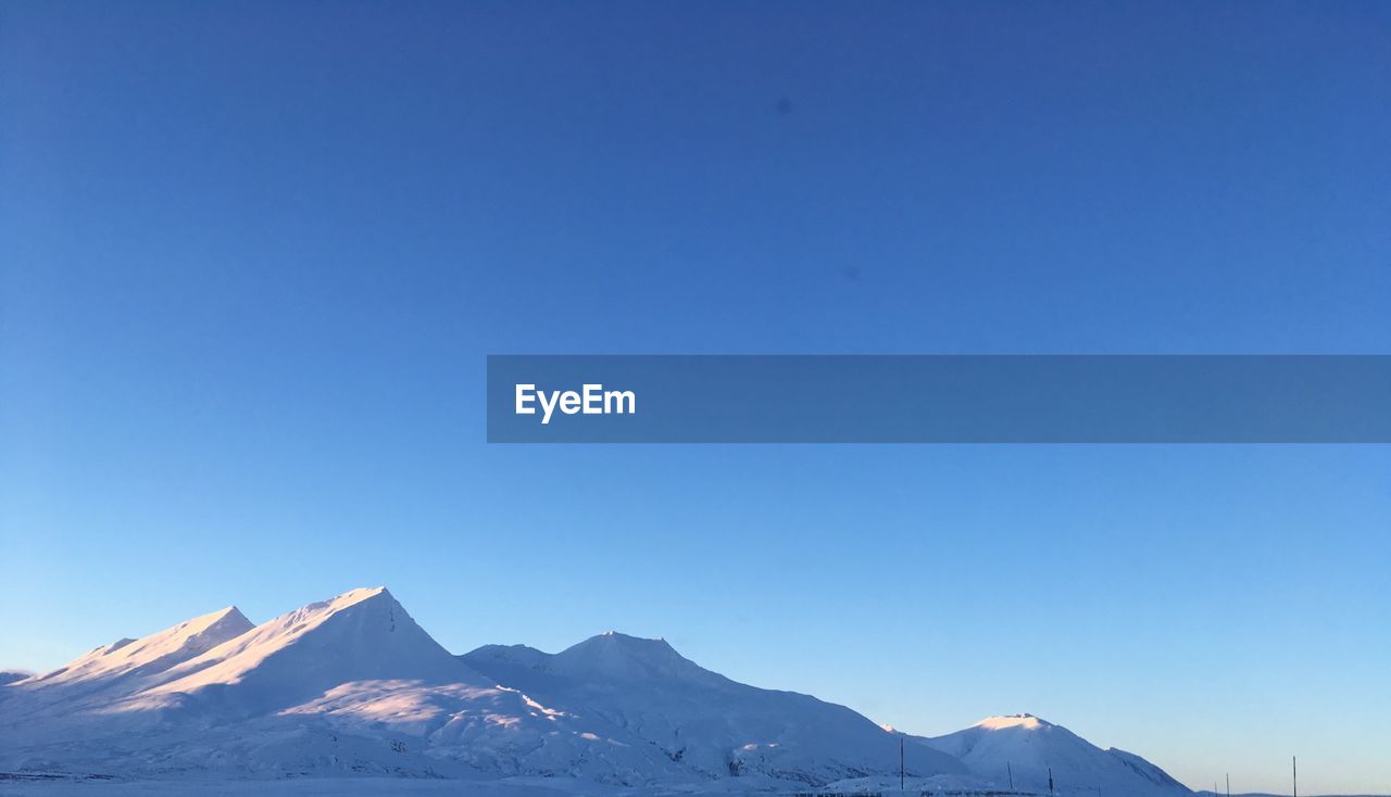 SNOWCAPPED MOUNTAIN AGAINST CLEAR BLUE SKY