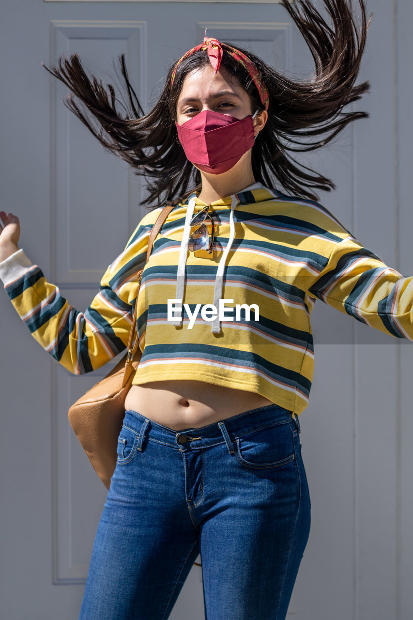 Lady wearing mask from her bag to protect herself from the epidemic