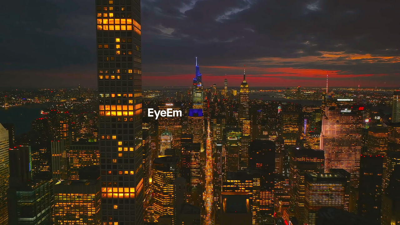 high angle view of illuminated cityscape against sky at night