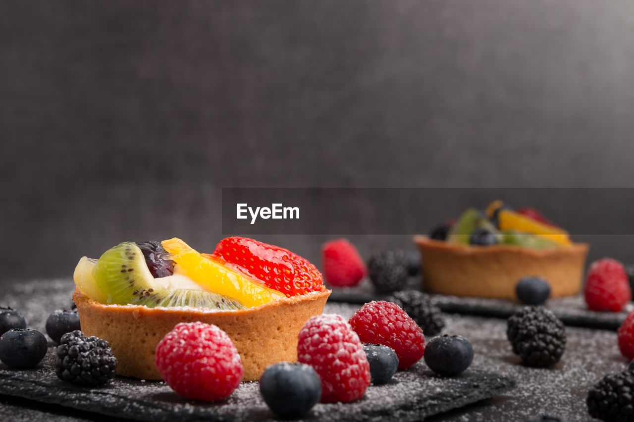 Close-up of dessert with fruits on table