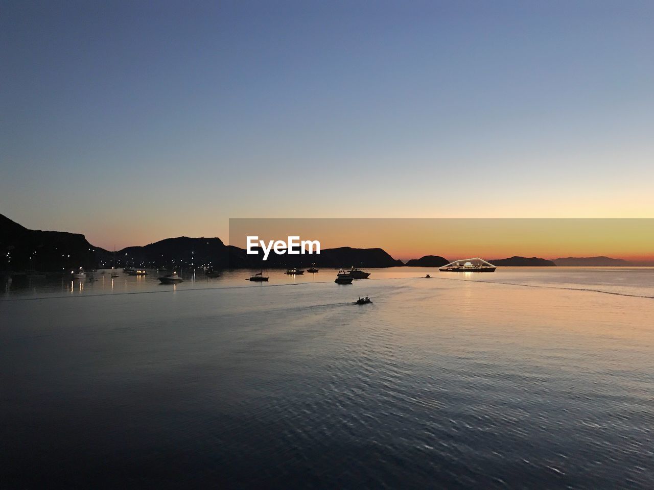 Scenic view of sea against clear sky during sunset