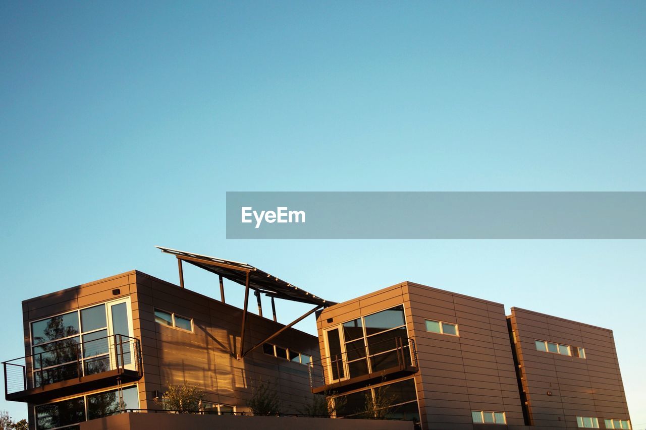 LOW ANGLE VIEW OF BUILDINGS AGAINST CLEAR SKY