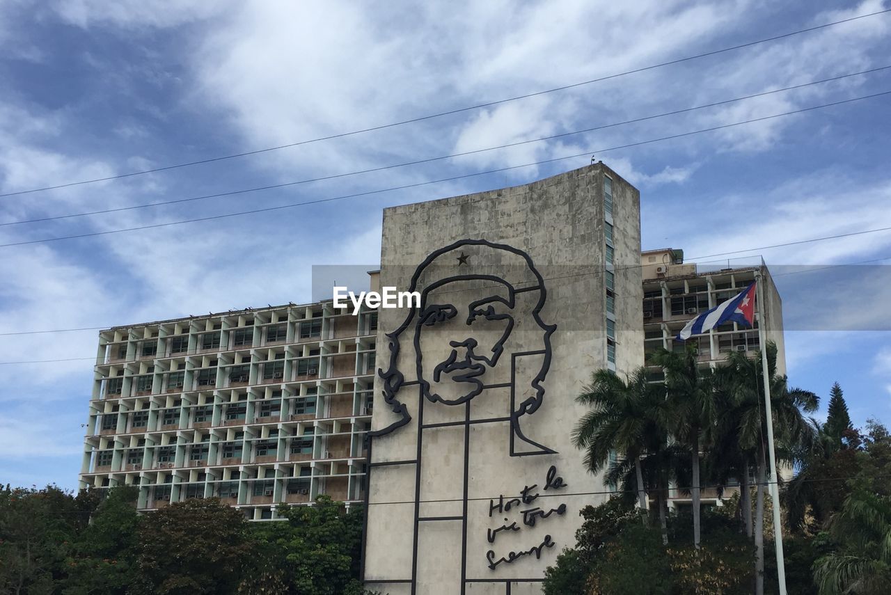 Low angle view of building against cloudy sky