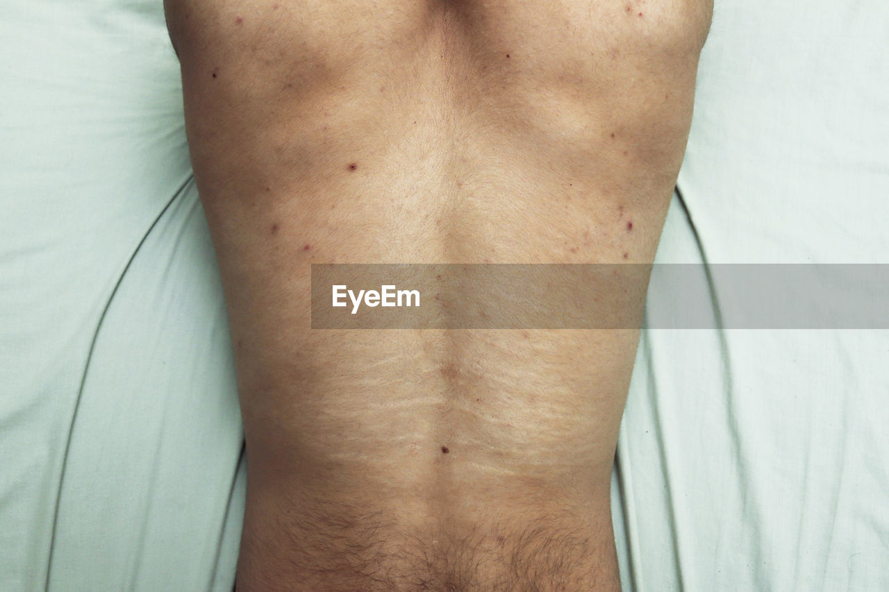 midsection of man touching abdomen