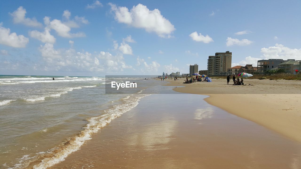 Building in city at beach against sky