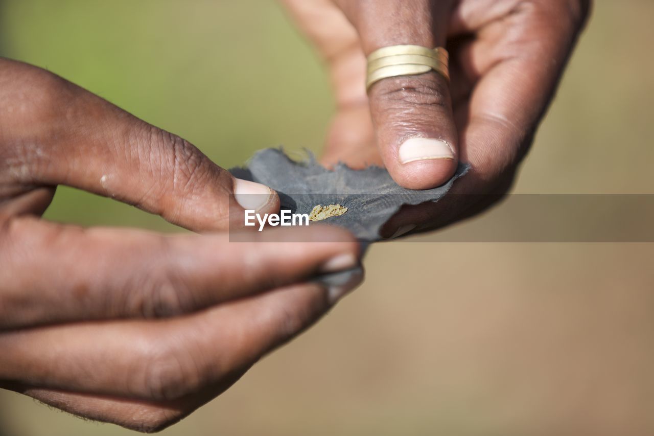 Cropped hands of person holding object