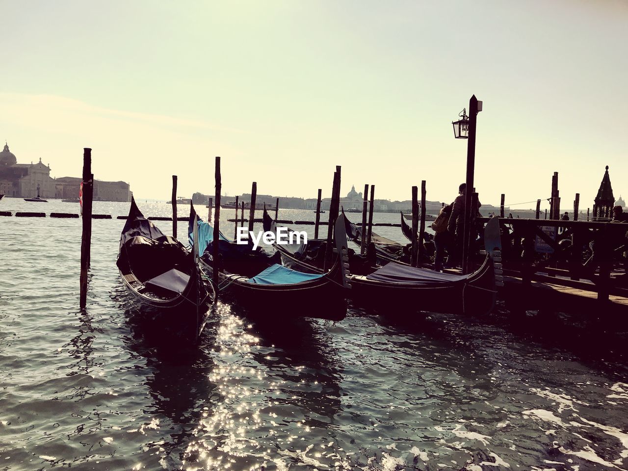 Gondolas moored on grand canal in city