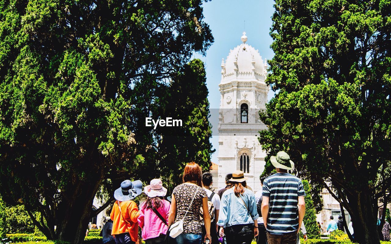 Rear view of tourists looking at jeronimos monastery