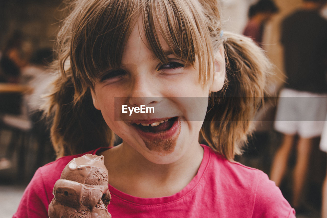 Close-up of girl eating chocolate ice cream cone