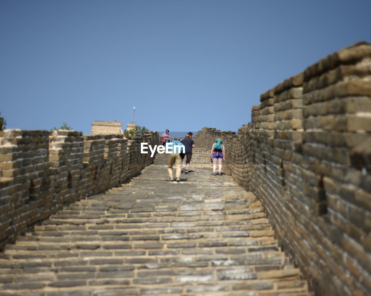 Low angle view of people at great wall of china against clear sky