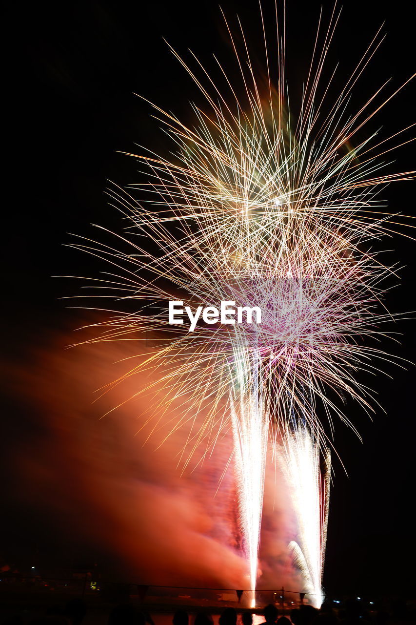 Low angle view of firework display at night