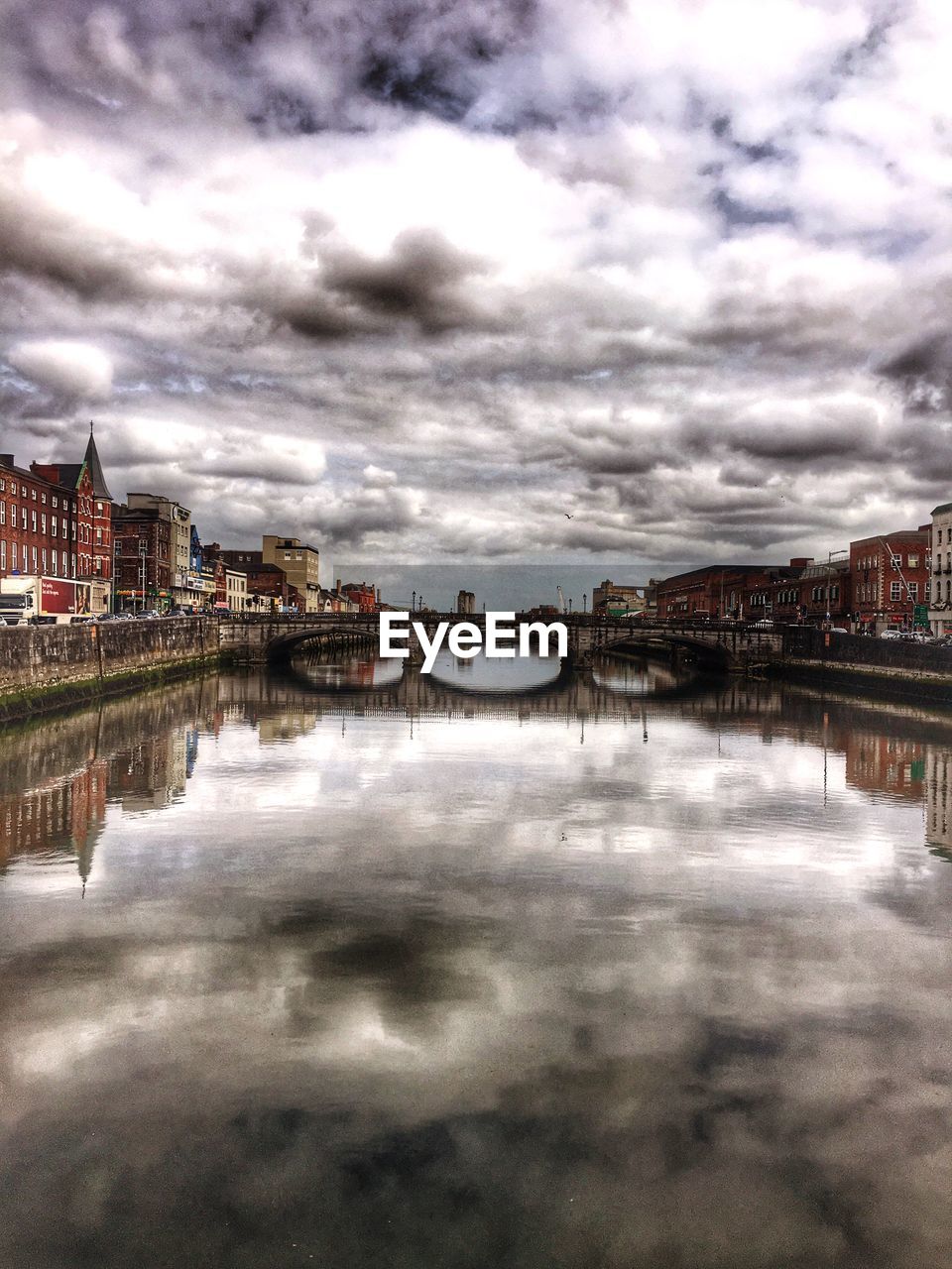 VIEW OF RIVER AGAINST CLOUDY SKY