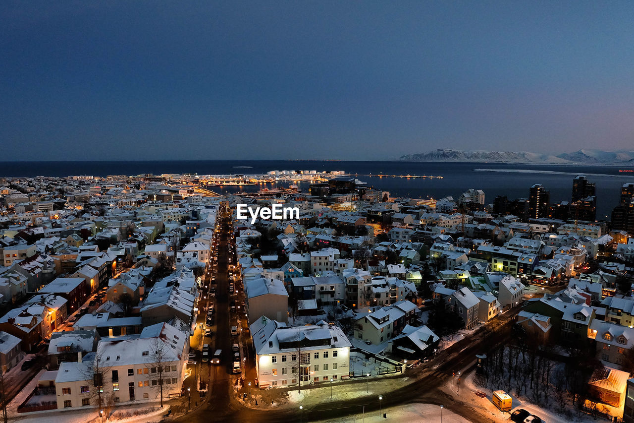 High angle view of illuminated cityscape against clear sky