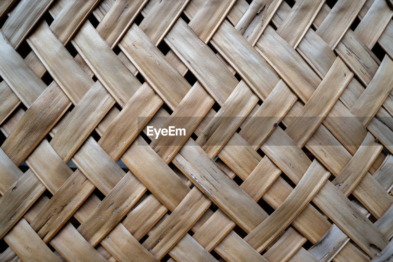 Woven coconut leaves as a traditional room divider.