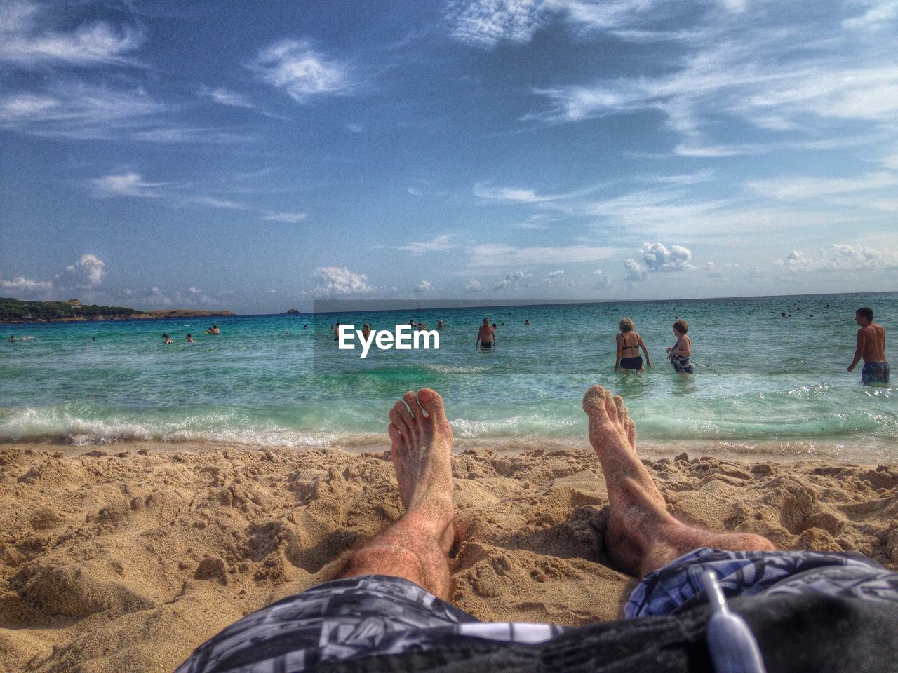 TOURISTS RELAXING ON BEACH