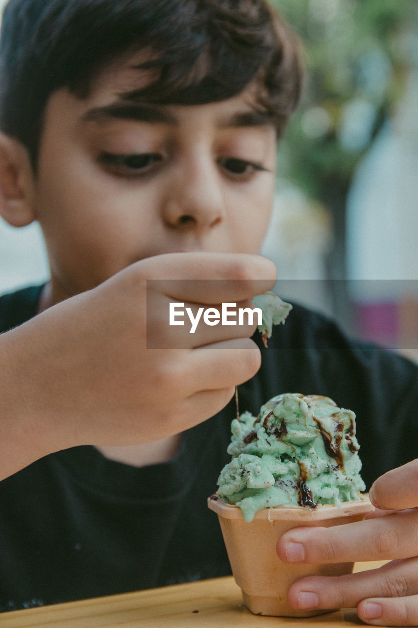 Close-up portrait of boy holding ice cream