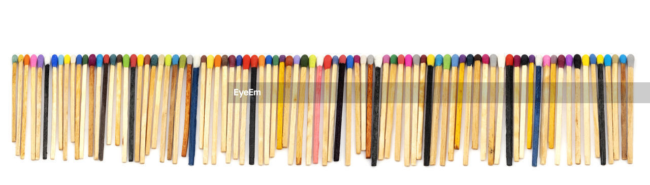 Multicolored matchsticks on white paper