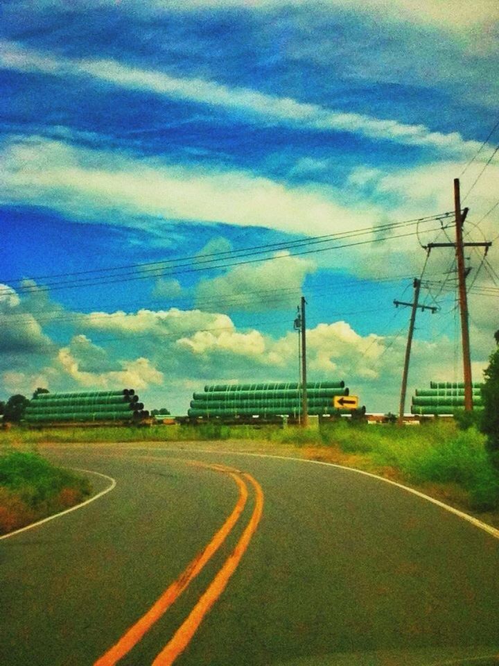 EMPTY ROAD WITH CLOUDY SKY IN BACKGROUND