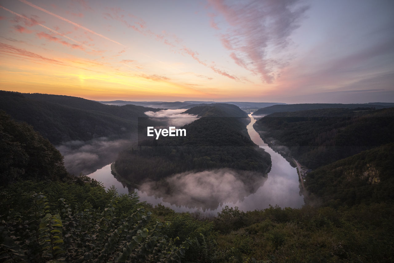 Majestic sunrise and foggy landscape at saarschleife  in mettlach, saarland, view from cloef. 