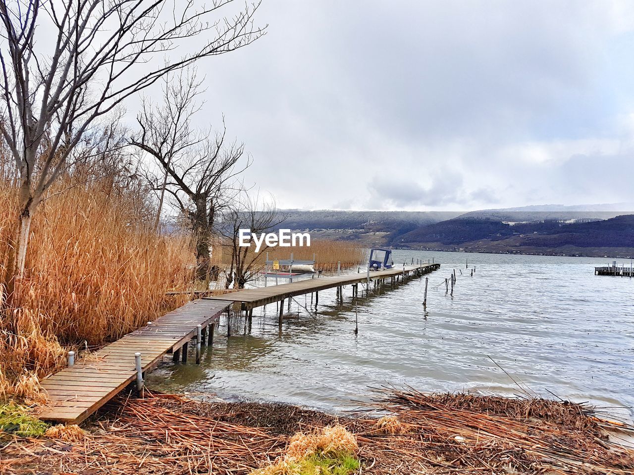 Scenic view of lake against sky during winter