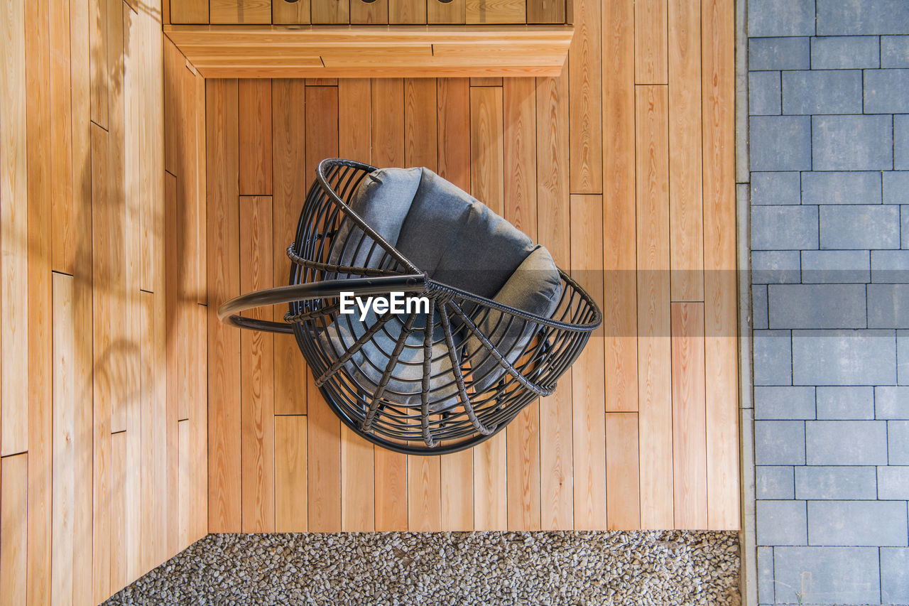 Outdoor patio seat on the brand new elegant backyard garden exotic wood made deck. top view.