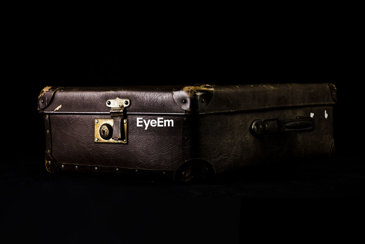 Close-up of luggage over black background