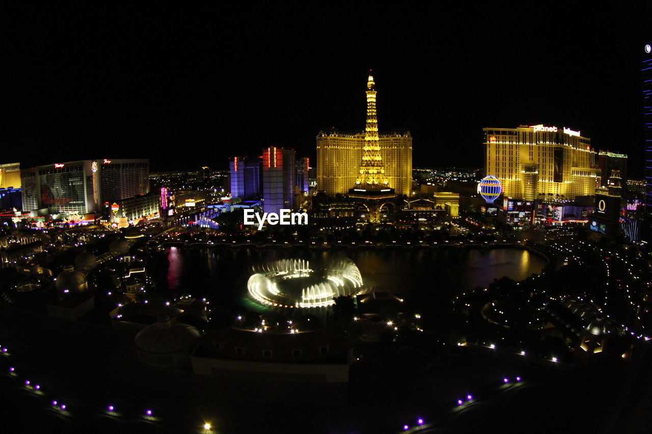 VIEW OF ILLUMINATED CITYSCAPE AT NIGHT