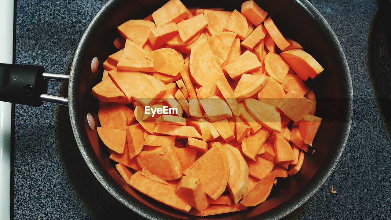 High angle view of sweet potato slices in cooking pan