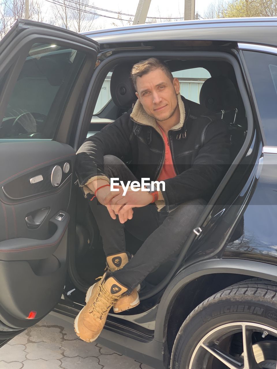 Portrait of young man sitting in car