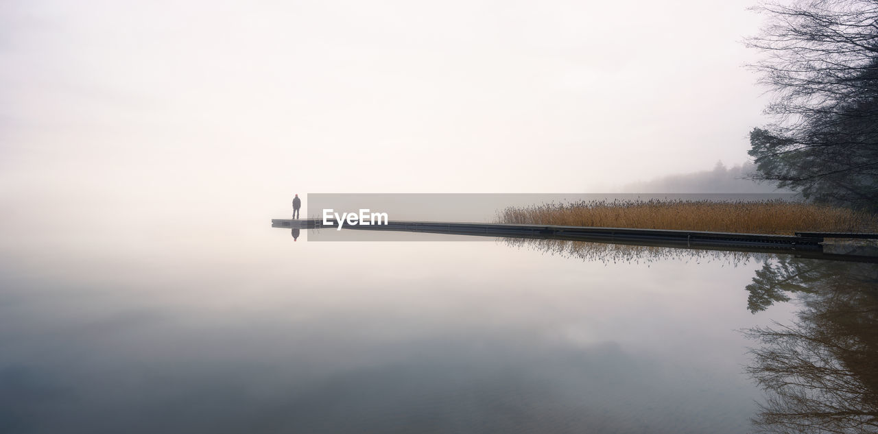 SCENIC VIEW OF LAKE BY TREES AGAINST SKY