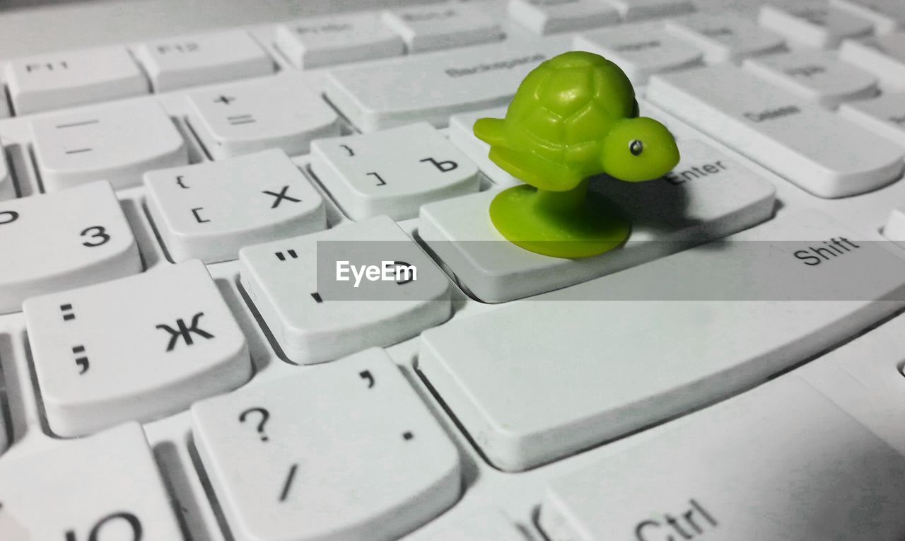 CLOSE-UP OF COMPUTER KEYBOARD IN BATHROOM