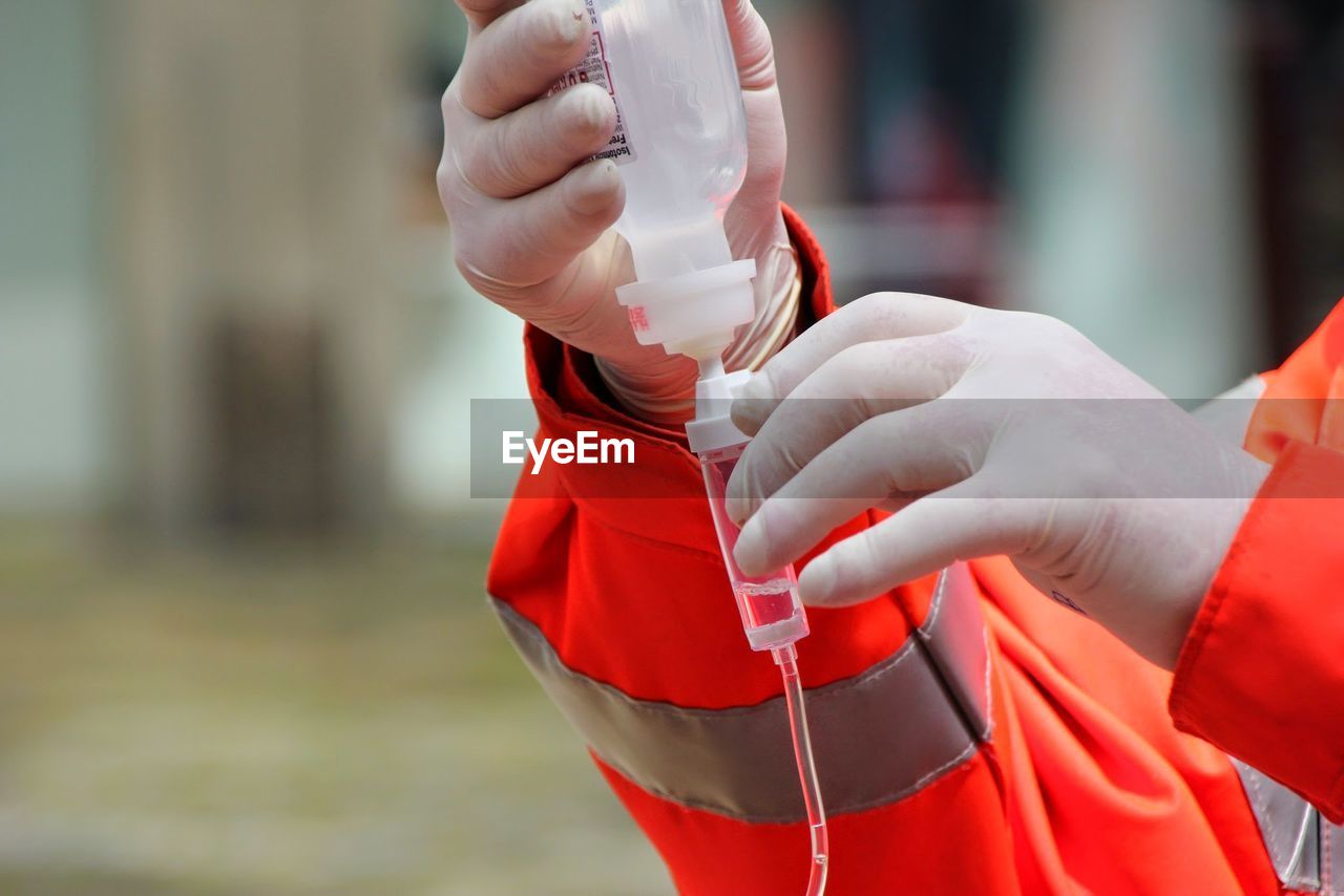 Cropped image of nurse checking iv drip