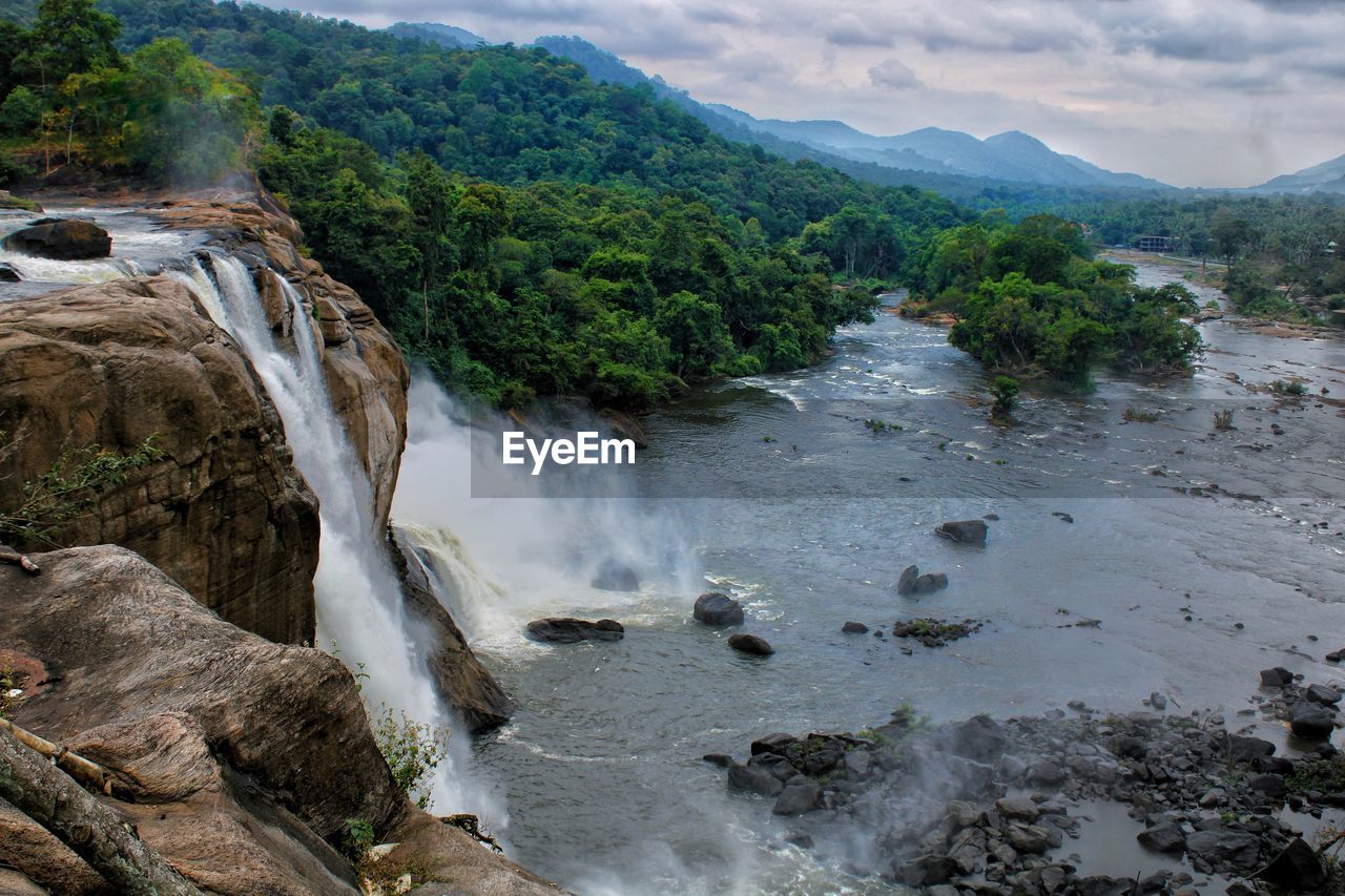 SCENIC VIEW OF WATERFALL AGAINST ROCKS