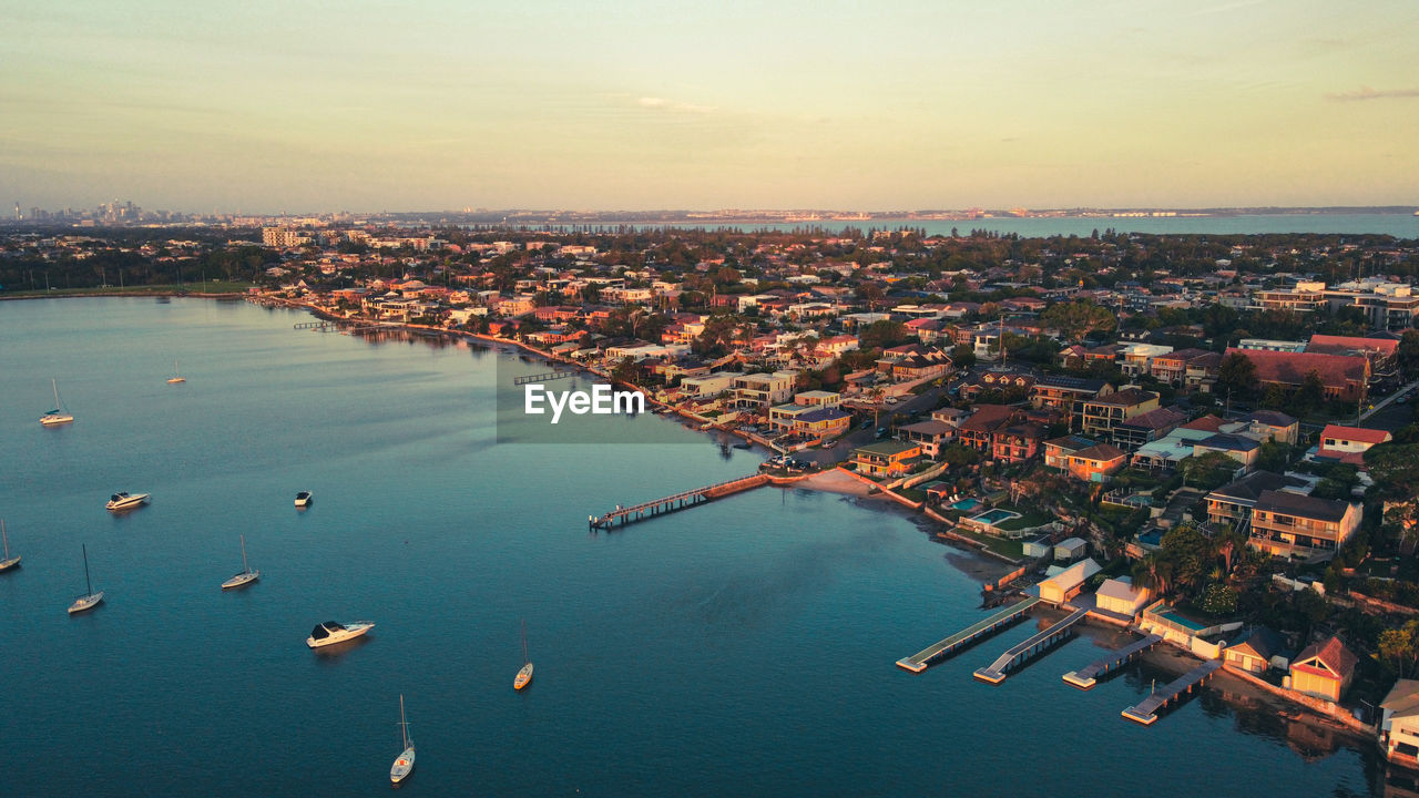 High angle view of townscape by sea