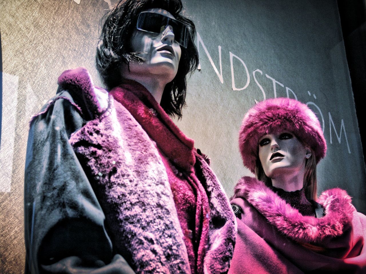 Low angle view of mannequins displayed in clothing store