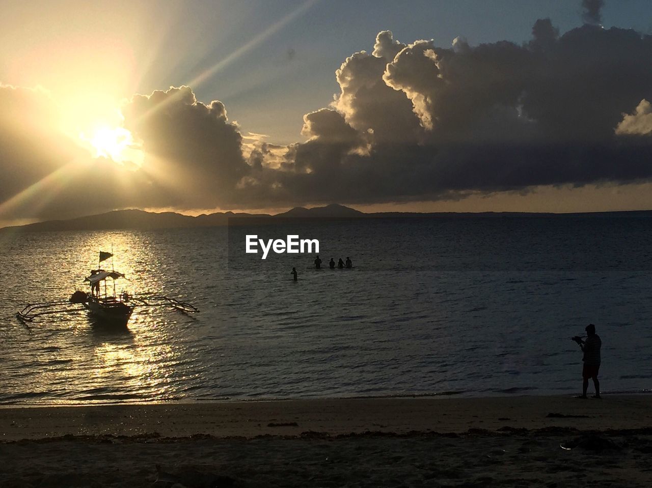 Scenic view of sea against cloudy sky during sunset