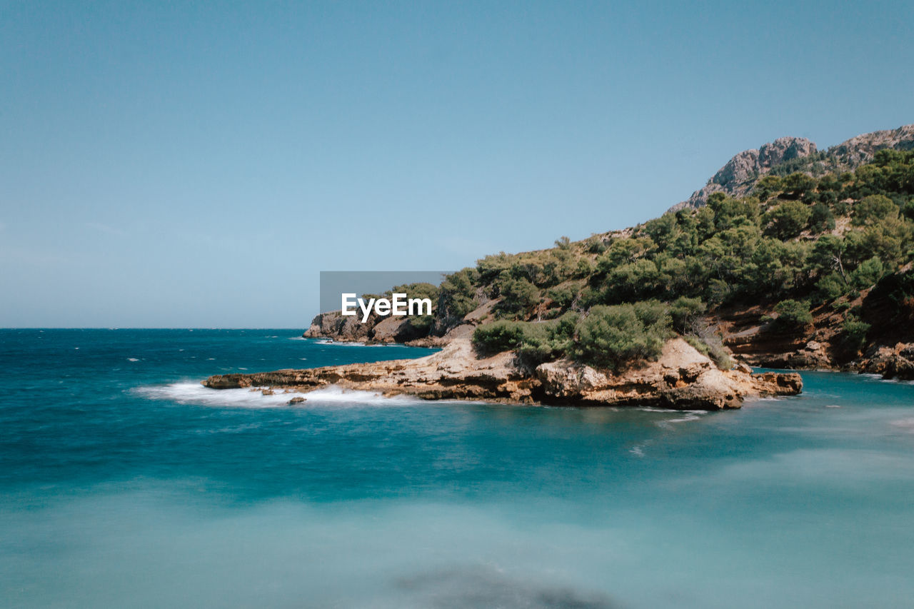 Scenic view of sea against clear blue sky